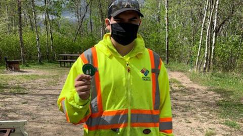 Kenosee Lake resident shows his COVID-19 vaccination sticker.