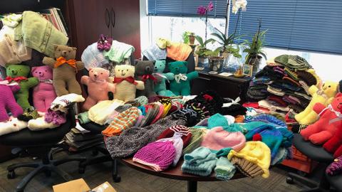 table full of knitted items