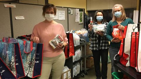 Three Ladies packaging gifts