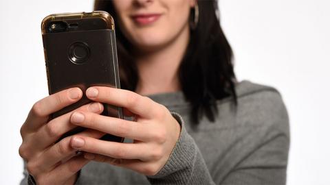 women holding cell phone