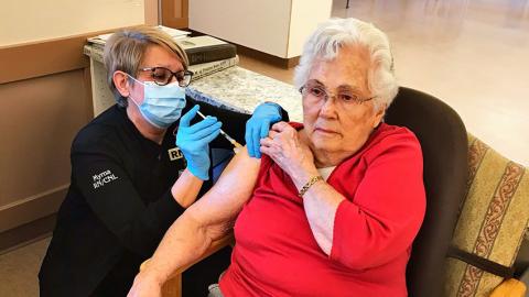 senior woman receiving vaccination