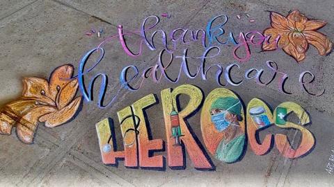 Sidewalk chalk art says 'thank you healthcare heroes'