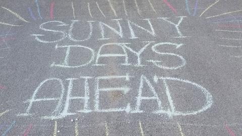 Chalk art that says 'Sunny Days Ahead'