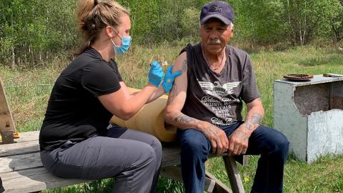 Nurse gives COVID-19 vaccine to La Loche resident.