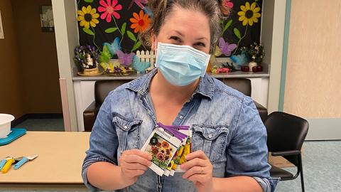 Susan Dyck holds packets of flower seeds.