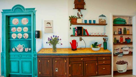 Wall artwork includes cupboards and dishes to look like a home kitchen.