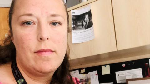 Dr. Jasmine Hasselback sits at her computer in her office.