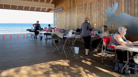 Vaccine clinic set up in a shelter near the beach at Waskesiu