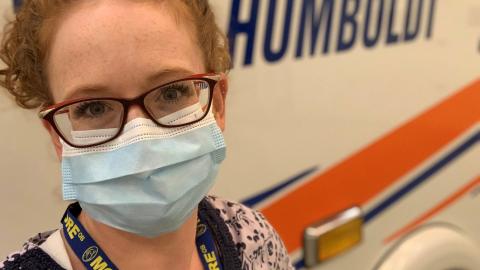 Rural RN masked, in ambulance bay