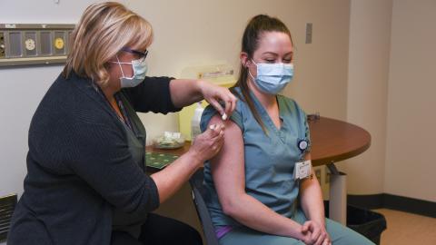 A member of SHA staff receives a COVID-19 vaccination.