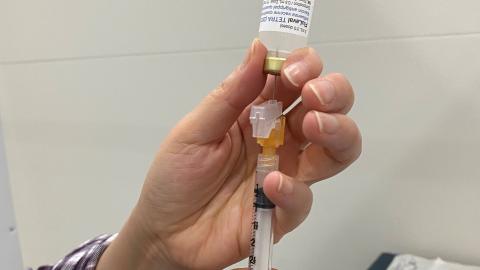 A flu shot is prepared for administration