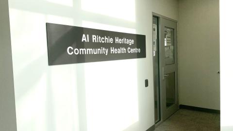 A hallway with a sign that reads Al Ritchie Heritage Community Health Centre.