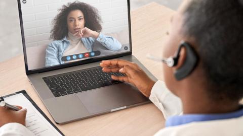 A health-care provider meets virtually with a patient.