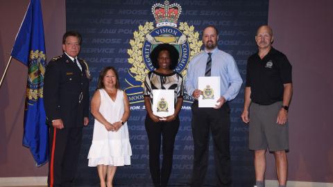 Police Chief Rick Bourassa, Board of Police Chair Mary Lee Booth, Nimone Campbell, Travis Philipation.