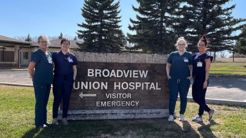 Four members of the nursing team in Broadview, standing beside the Broadview Union Hospital Visitor Emergency sign.