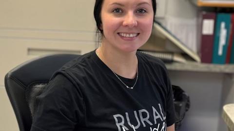 RN, Kashina Mahon, seated in front of a computer keyboard in the nursing station at Rosetown and District Health Centre.