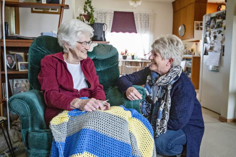 Elderly woman and daughter talking