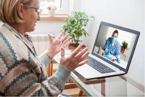 Women on computer talking to health care professional