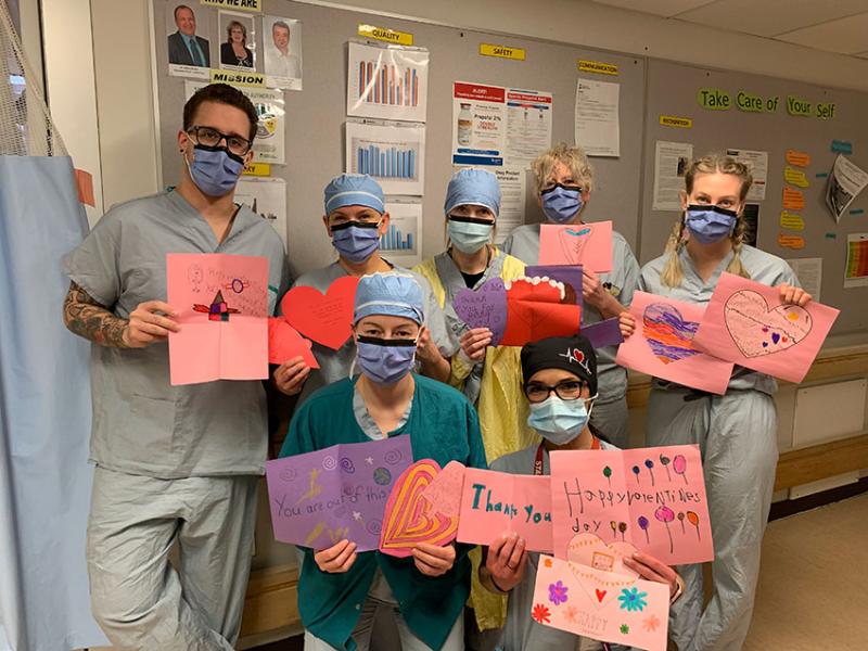 group of medical staff holding cards