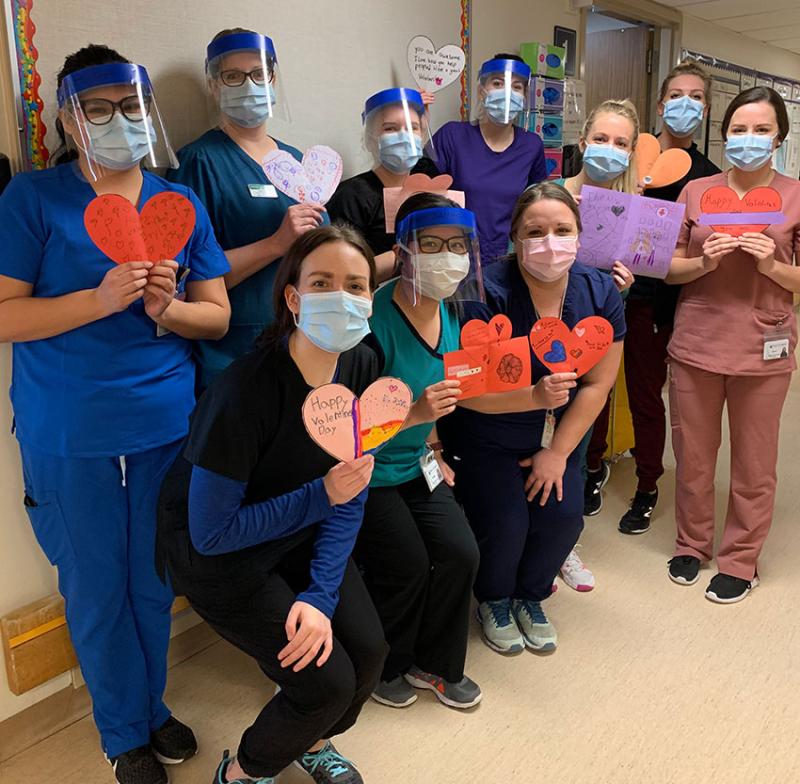 group of medical staff holding valentines