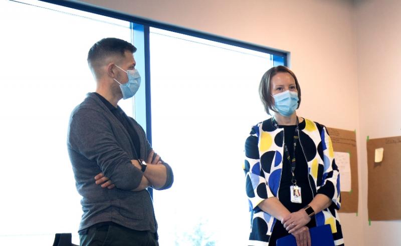 two people standing wearing masks