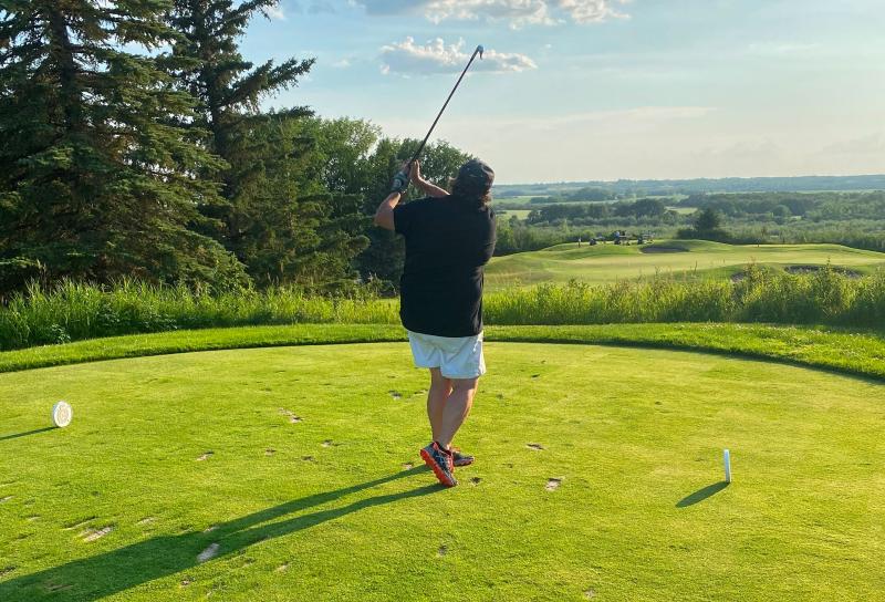 Kathy Ziglo teeing off on the golf course.