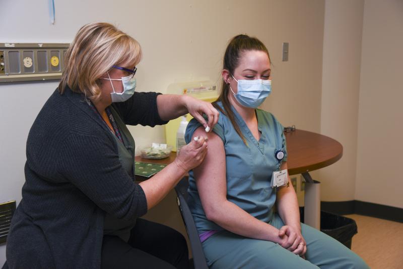 A member of SHA staff receives a COVID-19 vaccine.