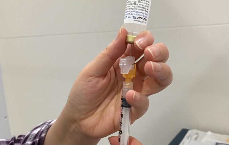 A flu shot is prepared for administration