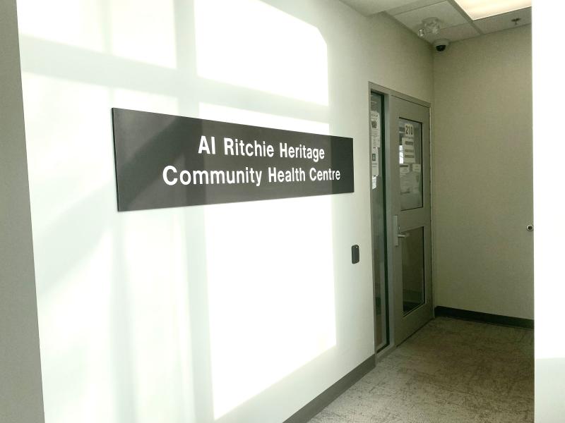 A hallway with a sign that reads Al Ritchie Heritage Community Health Centre.