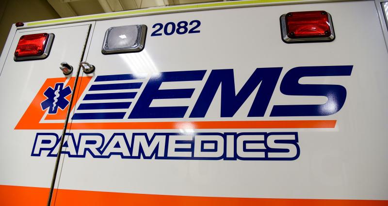 The side of an ambulance with the EMS logo. 