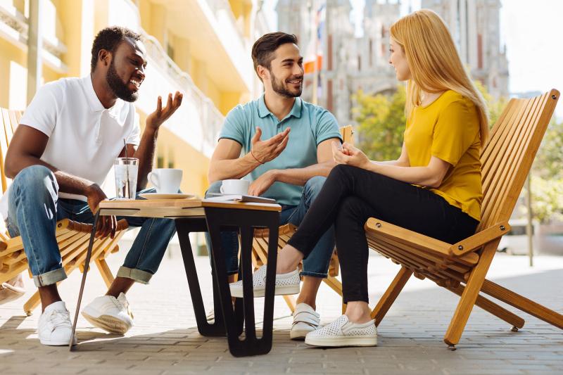 Three people engaging in a friendly conversation.