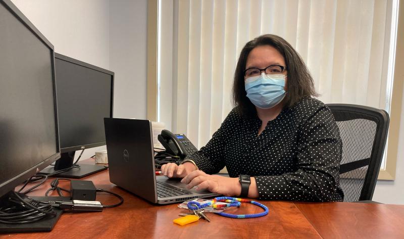 Woman in office in front of a computer.