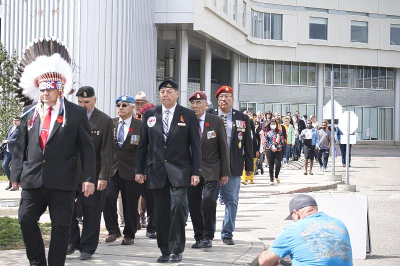 Grand Chief Dave Gamble leads a procession of First Nations and Métis veterans, honoured guests, the public and SHA staff to the Truth and Reconciliation Flag Raising at Saskatoon City Hospital.