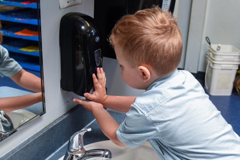 child washing his hands