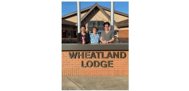 staff members standing outside Wheatland Lodge