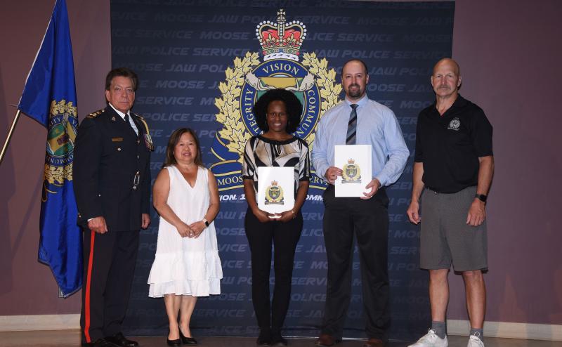 Police Chief Rick Bourassa, Board of Police Chair Mary Lee Booth, Nimone Campbell, Travis Philipation.