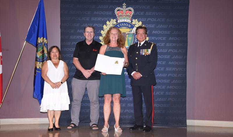 Police Chief Rick Bourassa, Board of Police Chair Mary Lee Booth, Heather Segall and Board of Police Commissioner member Kim Robinson. 