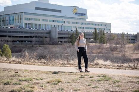 New respiratory therapist in front of Jim Pattison Children’s Hospital