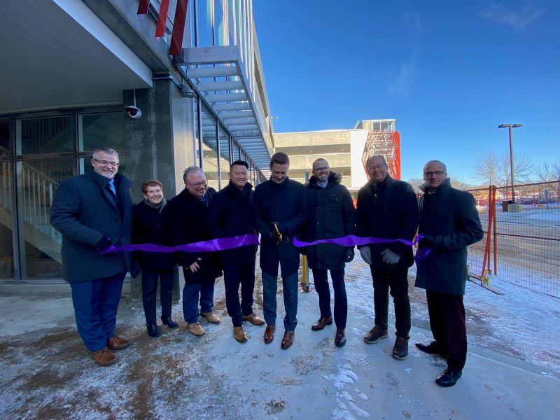 People standing for ribbon cutting of parkade